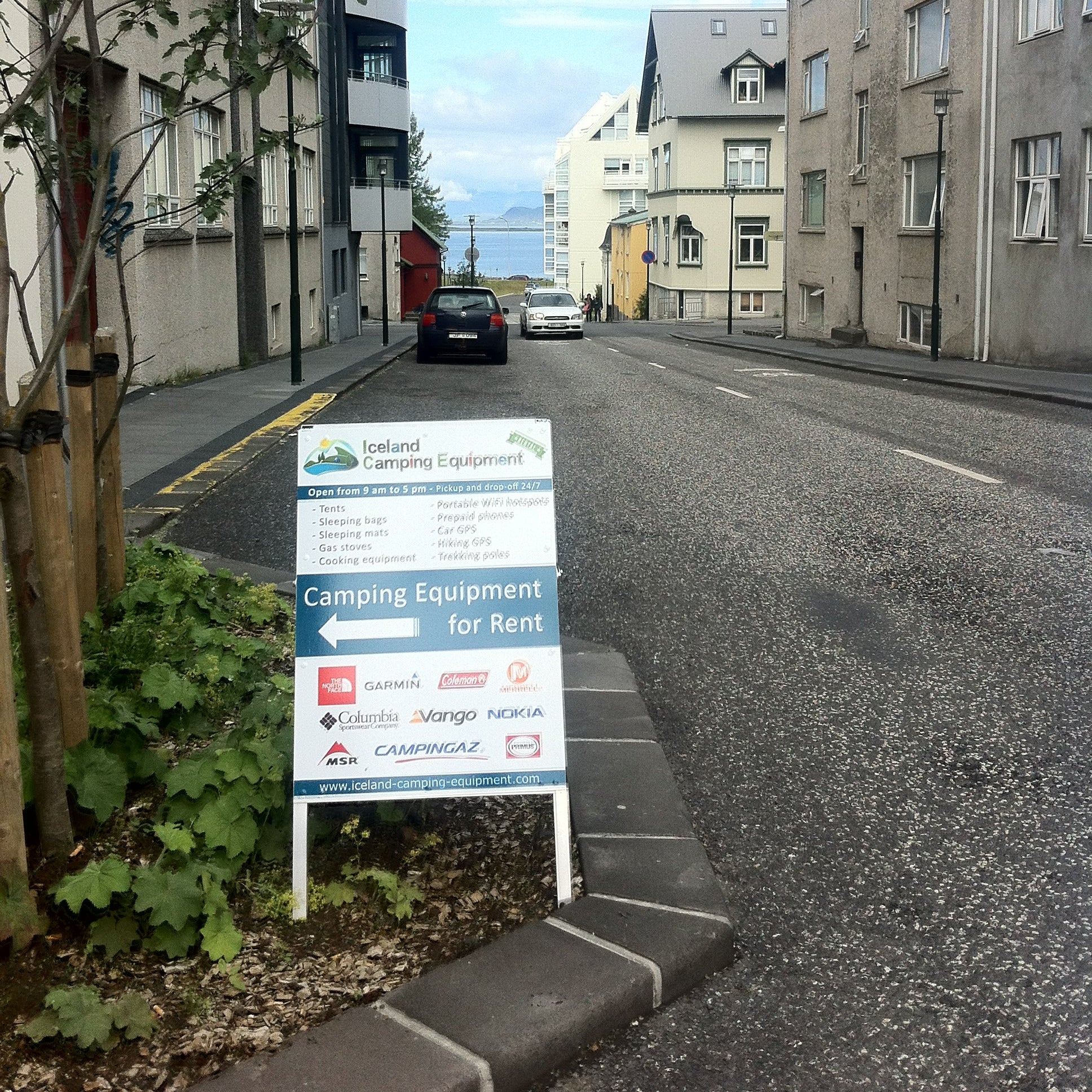 Street scene with buildings and a signboard on a clear day